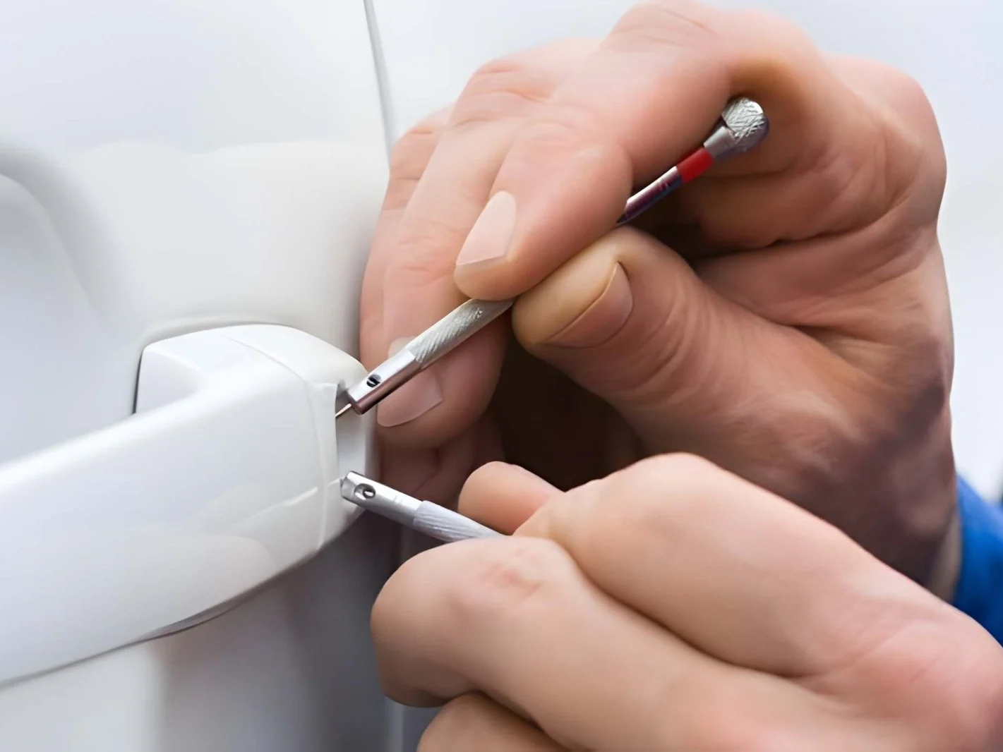 Hand holding lockpicker to open car door 11