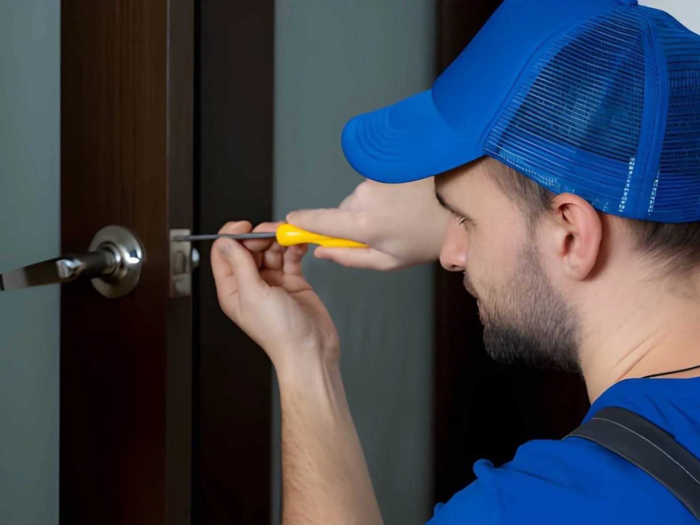 Handyman repair the door lock in the room
